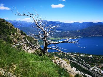 Scenic view of sea and mountains against blue sky