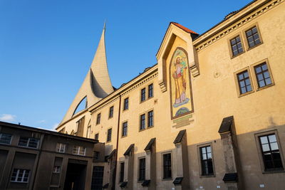 Low angle view of buildings against blue sky