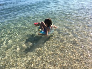 High angle view of girl swimming in sea