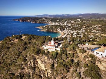 High angle view of townscape by sea against sky