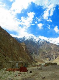 Scenic view of mountains against cloudy sky