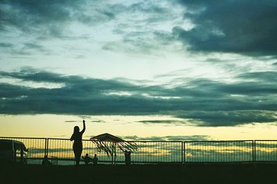 Sea against cloudy sky at sunset