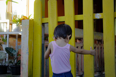 Boy standing against wall