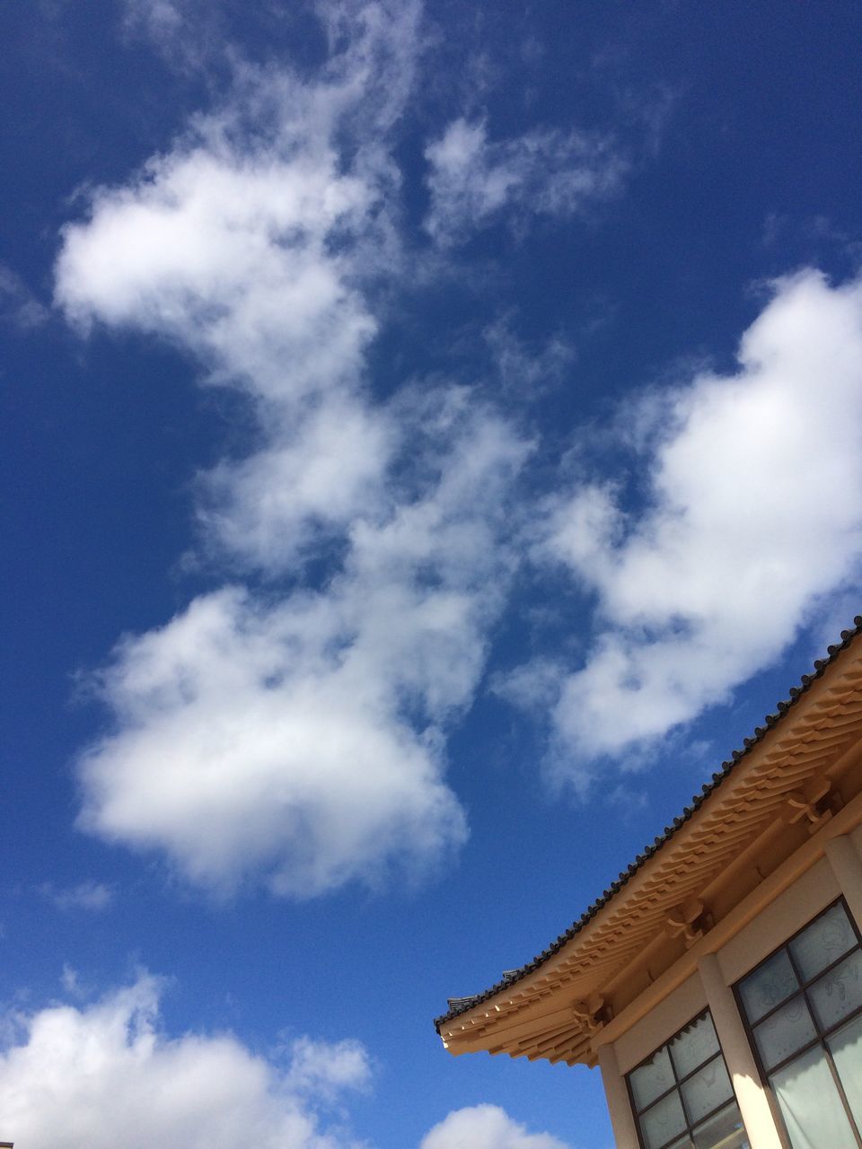 architecture, built structure, building exterior, low angle view, house, sky, roof, high section, day, blue, cloud - sky, outdoors, no people