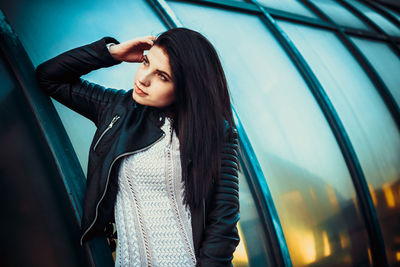 Young woman standing on street in city