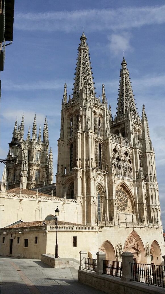 building exterior, architecture, place of worship, religion, built structure, church, spirituality, cathedral, sky, low angle view, steeple, dome, travel destinations, city, famous place, tower, travel, cloud - sky