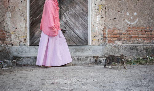 Woman standing against wall