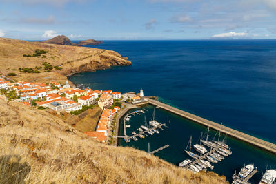 High angle view of sea and buildings against sky