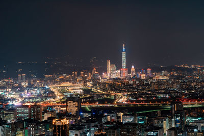 Aerial view of city lit up at night