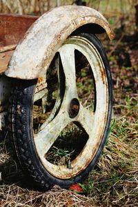 Close-up of old abandoned car on field