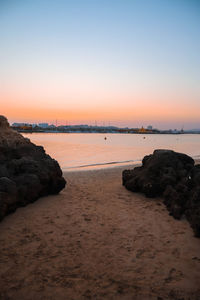 Scenic view of sea against clear sky during sunset