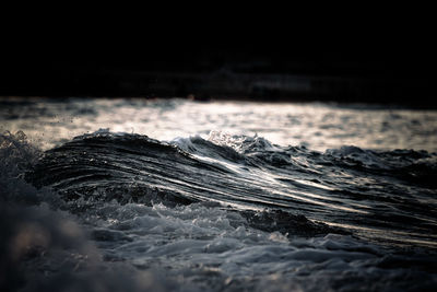 Close-up of water splashing in sea at night