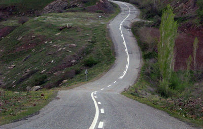 Empty road along countryside landscape