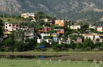 Scenic view of lake by buildings in town