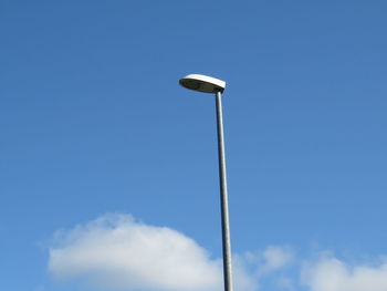 Low angle view of street light against blue sky