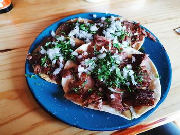 High angle view of pizza served on table