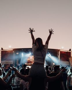 Rear view of people enjoying at music concert