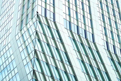 Low angle view of glass building against sky