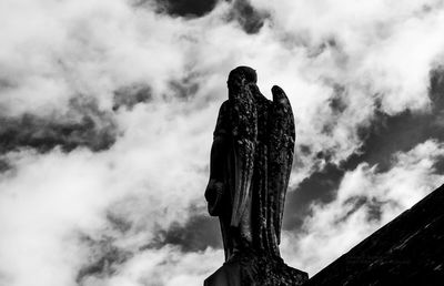 Low angle view of monument against cloudy sky