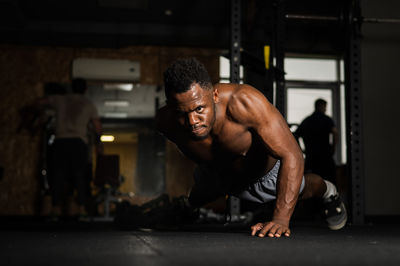 Portrait of man exercising at gym