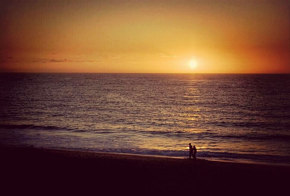 sea, horizon over water, sunset, water, silhouette, beach, scenics, tranquil scene, beauty in nature, sun, tranquility, shore, orange color, leisure activity, sky, idyllic, lifestyles, nature, men