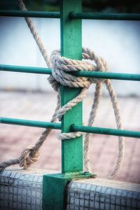 Close-up of rope tied on metal railing