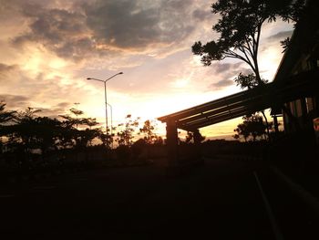 Silhouette trees against sky during sunset