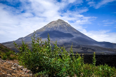 Scenic view of mountain against cloudy sky