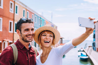 Portrait of smiling young woman using smart phone