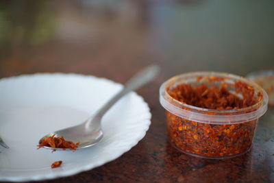 Close-up of spicy dried shrimp in container on table