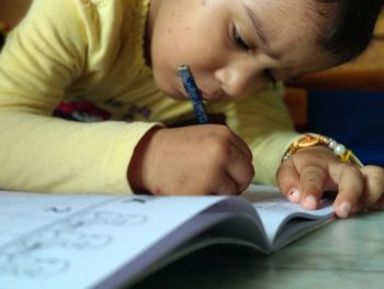 Close-up of baby boy holding book