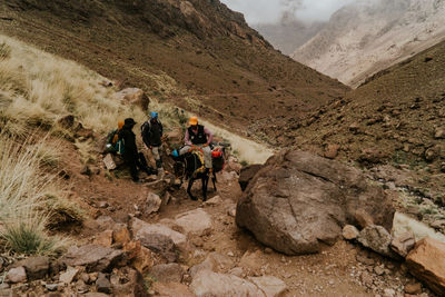 Group of people walking on rocks