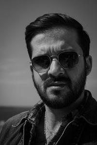 Close-up portrait of young man wearing sunglasses