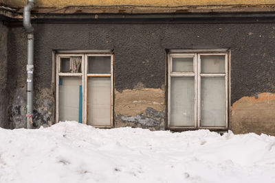 Closed door of building covered with snow