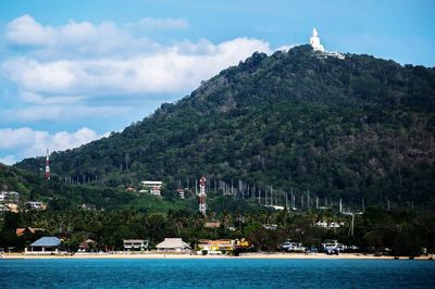 Scenic view of sea and mountains against sky