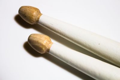 High angle view of drumsticks on white background