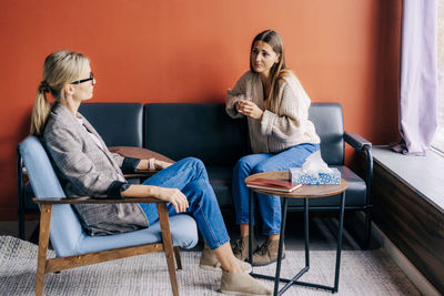 Female psychologist listening to a depressed woman in an appointment.