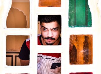 Young man looking through window