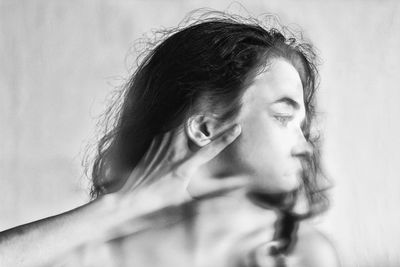 Blurred motion of hand slapping woman on face