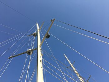 Low angle view of cables against clear blue sky