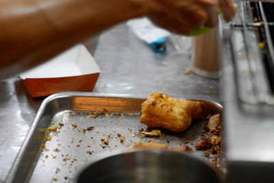 Close-up of person preparing food on table