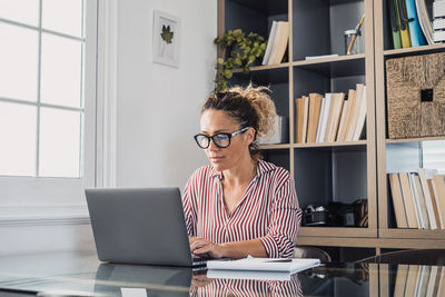 Full length of woman working on table