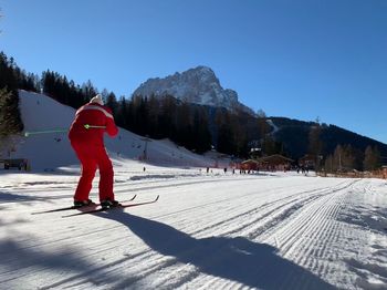 Person skiing on snowcapped mountain against sky