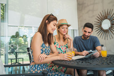 Young couple sitting on table