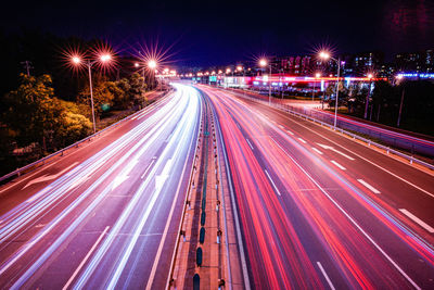 High angle view of light trails on road at night