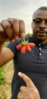 Midsection of man holding fruits