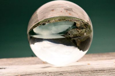 Close-up of crystal ball on glass table