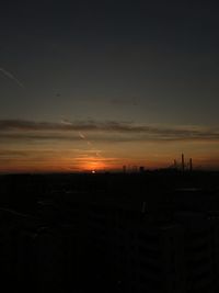 Silhouette cityscape against sky during sunset