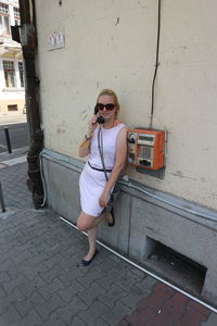 Woman talking on telephone in city