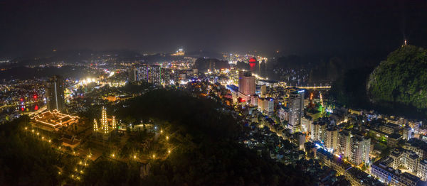 High angle view of illuminated city buildings at night